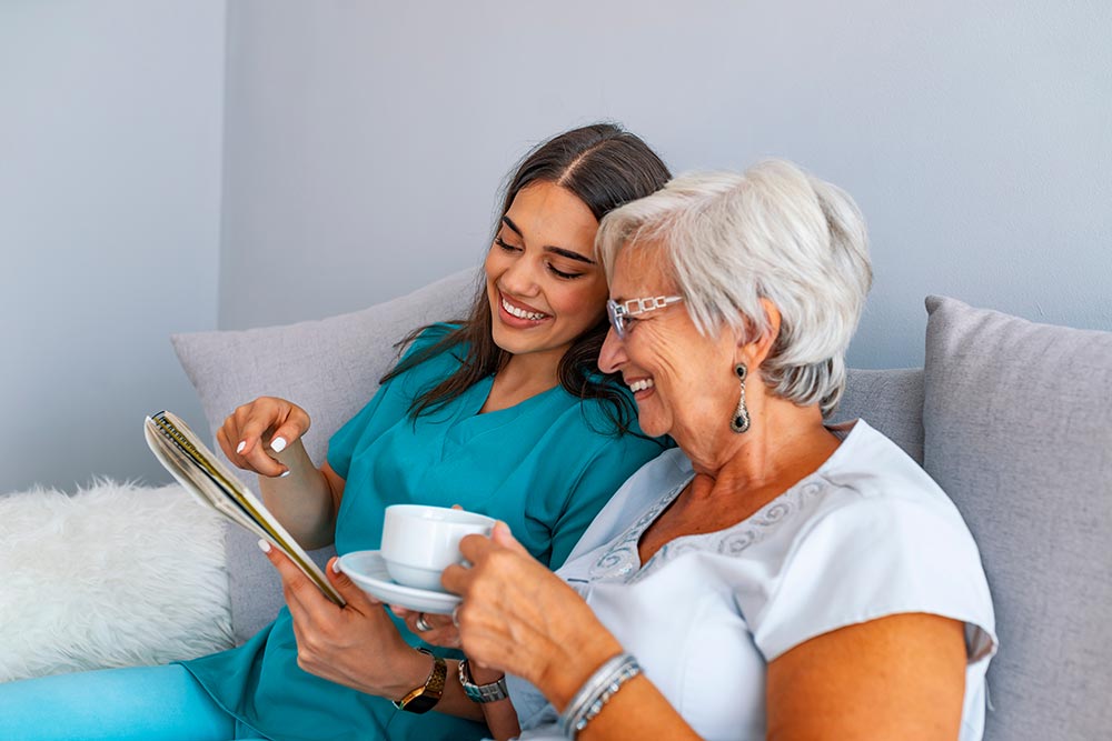 Please Read Carefully: Nurse and elderly lady read healthcare information together