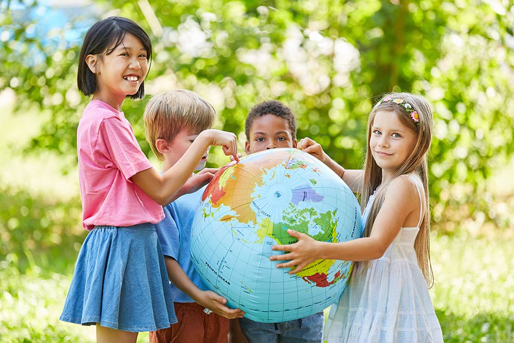 Please Read Carefully: Children from several countries hold a large globe of the world